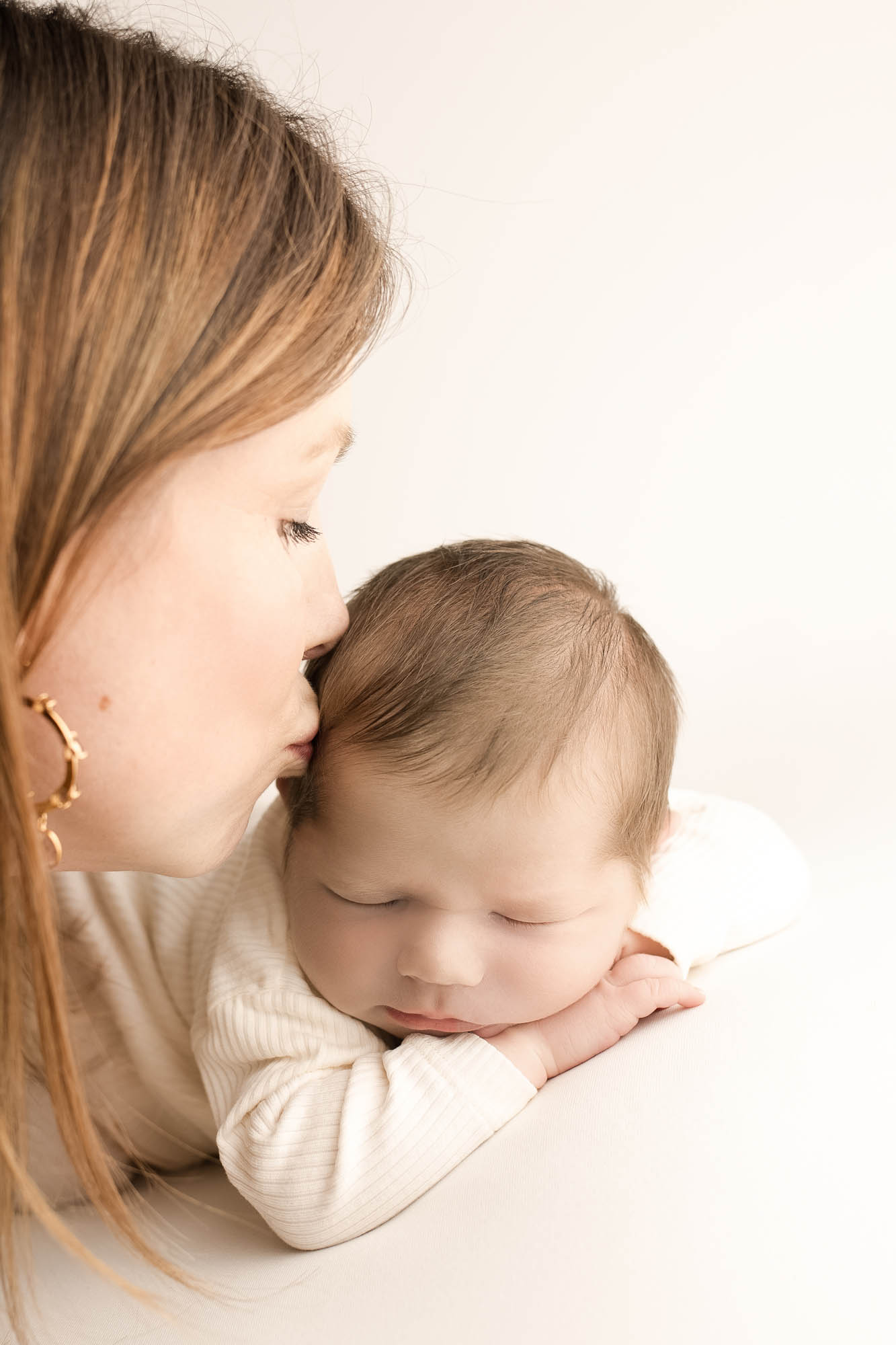 Moeder kust baby zoon op hoofd tijdens newbornshoot in Zundert bij Beeldend Floor